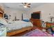 Inviting main bedroom featuring a large bed, dresser, and wood look floors at 2415 Impatien Dr, Charlotte, NC 28215