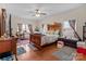 Spacious main bedroom featuring a ceiling fan, wood look floors, and natural lighting at 2415 Impatien Dr, Charlotte, NC 28215