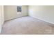 Well-lit bedroom with neutral carpeting and a window at 271 Wendover Dr, Salisbury, NC 28147