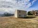 Tan house exterior with backyard and partial view of neighborhood at 271 Wendover Dr, Salisbury, NC 28147