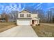 Two-story house with beige siding, a red door, and a two-car garage at 271 Wendover Dr, Salisbury, NC 28147