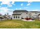 Fenced backyard with a patio, seating, and a well-maintained lawn at 2727 Cypress Oak Ln, Gastonia, NC 28056