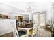 Open dining room with a wooden table, six chairs, chandelier and an area rug, leading to the living spaces at 2727 Cypress Oak Ln, Gastonia, NC 28056