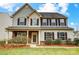 Charming two-story home featuring stone accents, a covered front porch, and well-maintained landscaping at 2727 Cypress Oak Ln, Gastonia, NC 28056