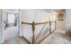 Upstairs hallway featuring wood and white railing, carpet and a view into a bedroom at 2727 Cypress Oak Ln, Gastonia, NC 28056