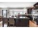 Open kitchen with dark wood cabinets, granite countertops, and a view into the dining area at 2727 Cypress Oak Ln, Gastonia, NC 28056