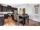 Stylish kitchen featuring dark cabinetry, stainless steel appliances, and central island with seating at 2727 Cypress Oak Ln, Gastonia, NC 28056