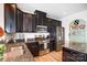 Modern kitchen featuring stainless steel appliances, granite countertops, and dark wood cabinets at 2727 Cypress Oak Ln, Gastonia, NC 28056