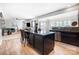 Modern kitchen island with seating, seamlessly connected to the living and dining areas at 2727 Cypress Oak Ln, Gastonia, NC 28056