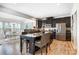 Modern kitchen with dark wood cabinets, stainless steel appliances, and dining area in background at 2727 Cypress Oak Ln, Gastonia, NC 28056