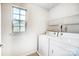 Practical laundry room with a window, shelving, and modern appliances at 2727 Cypress Oak Ln, Gastonia, NC 28056