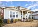 Covered patio with seating area, ceiling fan, and access to the backyard at 328 Sensibility Cir, Fort Mill, SC 29708