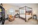 Spacious bedroom with a four-poster bed and built-in shelving at 328 Sensibility Cir, Fort Mill, SC 29708