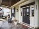 Front porch with a rocking chair, swing, and decorative planters at 328 Sensibility Cir, Fort Mill, SC 29708