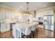 Modern kitchen with white cabinets, large island, and stainless steel appliances at 328 Sensibility Cir, Fort Mill, SC 29708