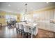 Bright kitchen boasts white cabinets, breakfast bar, and stainless steel appliances at 328 Sensibility Cir, Fort Mill, SC 29708