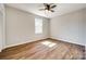 Bedroom with wood-look flooring, ceiling fan and large window at 3331 Center Rd, Chester, SC 29706