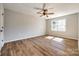 Sunny bedroom featuring a ceiling fan, a large window, neutral paint, and wood floors at 3331 Center Rd, Chester, SC 29706