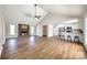 Open-concept living space featuring a brick fireplace, kitchen, dining area, and wood floors at 3331 Center Rd, Chester, SC 29706