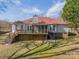 Rear view of a house with a deck, screened in porch, and a well-maintained yard at 3447 Nesting Ln, Fort Mill, SC 29708