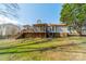 Backyard showcasing a well-maintained lawn with a deck and a screened porch at 3447 Nesting Ln, Fort Mill, SC 29708