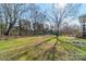 View of the expansive backyard featuring mature trees, a lush lawn, and plenty of space for recreation at 3447 Nesting Ln, Fort Mill, SC 29708