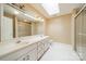 A bright bathroom with a skylight, double vanity, and glass-enclosed shower at 3447 Nesting Ln, Fort Mill, SC 29708