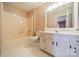 A well-lit bathroom with tub-shower combo, toilet, vanity and decorative wallpaper at 3447 Nesting Ln, Fort Mill, SC 29708