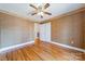 Comfortable bedroom featuring hardwood floors, an overhead fan, and convenient access to a closet at 3447 Nesting Ln, Fort Mill, SC 29708