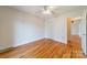 A spacious bedroom with hardwood floors, a ceiling fan, and an ensuite bathroom at 3447 Nesting Ln, Fort Mill, SC 29708