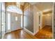 Inviting foyer with hardwood floors, decorative wallpaper and a chandelier, creating an elegant entrance at 3447 Nesting Ln, Fort Mill, SC 29708