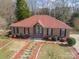 Inviting brick home with a landscaped front yard and red mulch flowerbeds and stepping stone walkway at 3447 Nesting Ln, Fort Mill, SC 29708