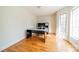 Bright home office featuring hardwood floors and a built-in desk, illuminated by natural light from a large window at 3447 Nesting Ln, Fort Mill, SC 29708