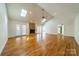 Spacious living room with hardwood floors, vaulted ceiling, skylights, and a stone fireplace for a cozy atmosphere at 3447 Nesting Ln, Fort Mill, SC 29708