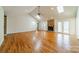 Bright living room with hardwood floors, vaulted ceiling, skylights, and a stone fireplace as focal point at 3447 Nesting Ln, Fort Mill, SC 29708