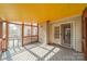 View of screened in porch with bright yellow ceiling with wood railing, for a relaxing outdoor space at 3447 Nesting Ln, Fort Mill, SC 29708