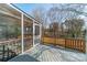 A screened in porch with wood railing offers a relaxing outdoor space with view of trees and greenery at 3447 Nesting Ln, Fort Mill, SC 29708