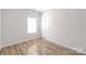 Simple bedroom with wood flooring and a window at 3714 Small Ave, Charlotte, NC 28269