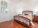 Cozy bedroom with hardwood floors, a large window, and a decorative bedframe at 3867 Azalea Trl, Denver, NC 28037