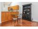 Charming dining area adjacent to the kitchen, featuring a glass table and built-in cabinetry at 3867 Azalea Trl, Denver, NC 28037