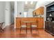 Cozy dining area with a glass table, modern chairs, and a view into the well-lit kitchen at 3867 Azalea Trl, Denver, NC 28037