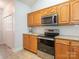 Well-lit kitchen features oak cabinets, granite countertops, stainless steel appliances, and white subway tile backsplash at 3867 Azalea Trl, Denver, NC 28037