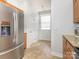 Kitchen features stainless steel refrigerator, tile floor, shaker cabinets, and a view of the sunny breakfast nook at 3867 Azalea Trl, Denver, NC 28037