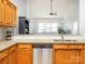 Kitchen boasts stainless steel dishwasher, tile backsplash, granite countertops, and oak cabinets at 3867 Azalea Trl, Denver, NC 28037