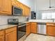 Well-lit kitchen features oak cabinets, granite countertops, stainless steel appliances, and white subway tile backsplash at 3867 Azalea Trl, Denver, NC 28037