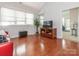 Bright living room featuring hardwood floors, a modern entertainment center, and ample natural light at 3867 Azalea Trl, Denver, NC 28037