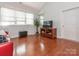 Bright living room featuring hardwood floors, a modern entertainment center, and ample natural light at 3867 Azalea Trl, Denver, NC 28037