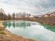 Pond view of the community pond, landscape and several properties in the background at 3867 Azalea Trl, Denver, NC 28037