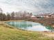 Scenic pond view surrounded by lush greenery and mature trees, enhancing the property's natural beauty at 3867 Azalea Trl, Denver, NC 28037