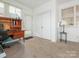 Bright sunroom featuring a large window, neutral carpet, and white walls at 3867 Azalea Trl, Denver, NC 28037